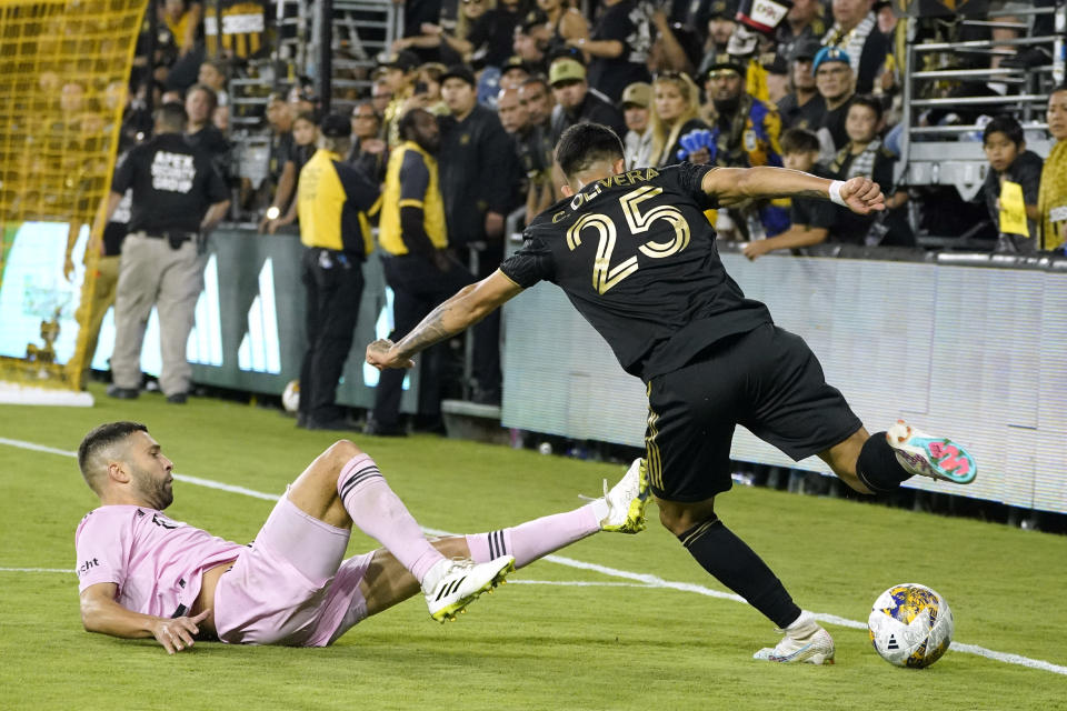 Los Angeles FC midfielder Cristian Olivera, right, tries to get past Inter Miami defender Harvey Neville during the second half of a Major League Soccer match Sunday, Sept. 3, 2023, in Los Angeles. (AP Photo/Mark J. Terrill)