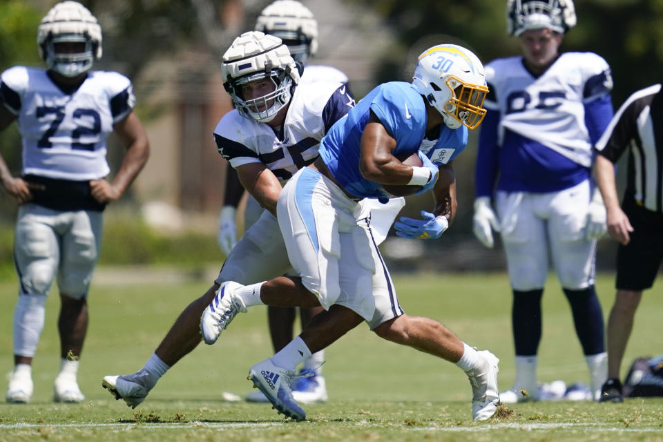 Dallas Cowboys outside linebacker Leighton Vander Esch (55) and Los Angeles Chargers running back Austin Ekeler (30) participate in drills during a combined NFL practice at the Los Angeles Rams' practice facility in Costa Mesa, Calif. Wednesday, Aug. 17, 2022. (AP Photo/Ashley Landis)