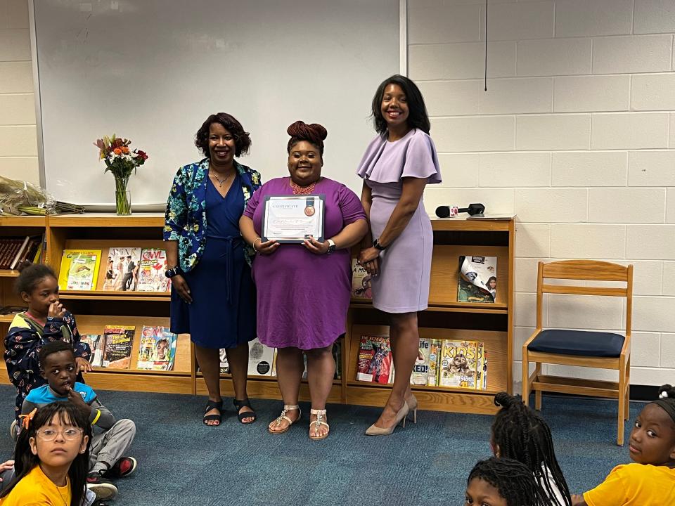 DaMeisha Fleming (center), a first-grade teacher at James Whitcomb Riley School 43, was chosen as the elementary Teacher of the Year for Indianapolis Public Schools. She's pictured with the school's principal, Lauren Johnson (left) and IPS Superintendent Aleesia Johnson (right).