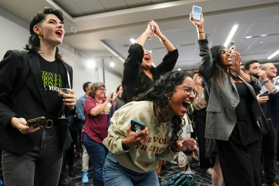 Nov 7, 2023; Columbus, Ohio, USA; Mason Hickman, left, and Shakti Rambarran, front, of the Ohio Women’s Alliance react during a gathering for supporters of Issue 1 at the Hyatt Regency Downtown. The issue establishes a constitutional right to abortion.