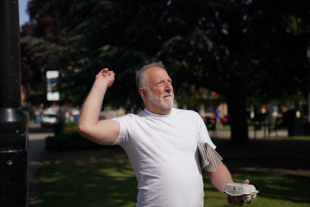 A man throws eggs at a statue of Baroness Margaret Thatcher as it is installed in her home town of Grantham, Lincolnshire