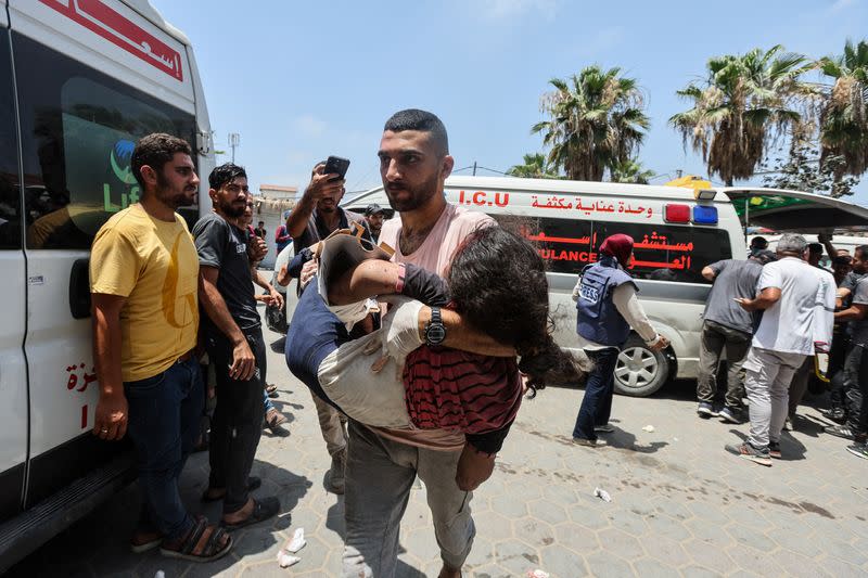 Palestinians wounded in an Israeli strike are brought to Al-Aqsa Martyrs Hospital, in Deir Al-Balah