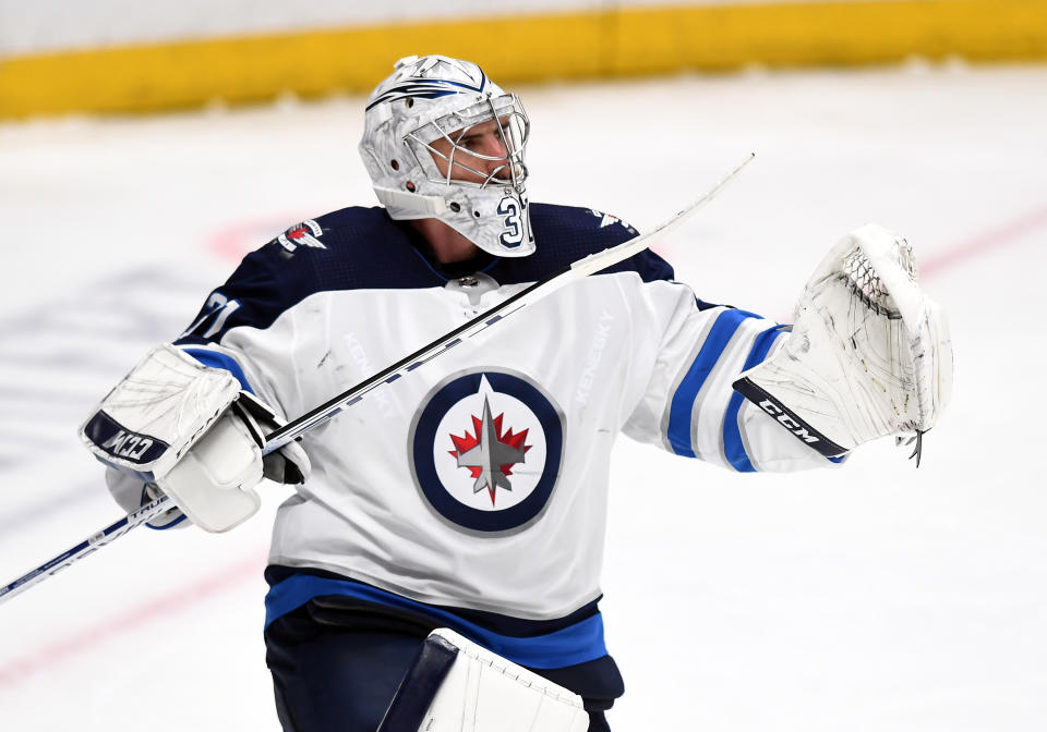 Winnipeg Jets goalie Connor Hellebuyck (37) pumps his stick after the Jets defeated the Anaheim Ducks