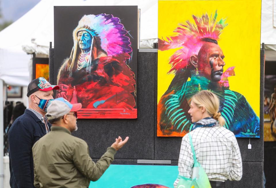 Guests talk about the work of indigenous artist Ray Goodluck of the Navajo Nation during the 2022 Southwest Arts Festival in Indio, Calif., Saturday, Jan. 29, 2022.