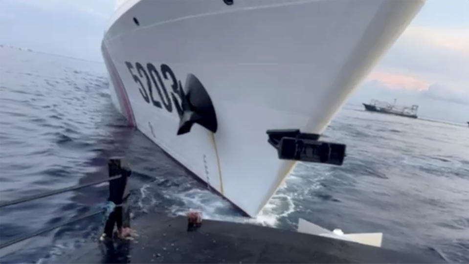 This image from a video released by the Armed Forces of the Philippines, shows a Chinese coast guard ship with bow number 5203 after bumping a Filipino supply boat as they approach Second Thomas Shoal, locally called Ayungin Shoal, at the disputed South China Sea on Sunday Oct. 22, 2023. (Armed Forces of the Philippines via AP)