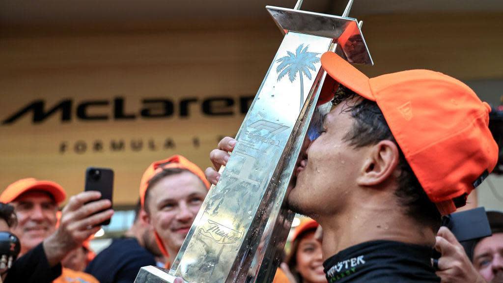 Lando Norris kisses the Miami Grand Prix winner's trophy