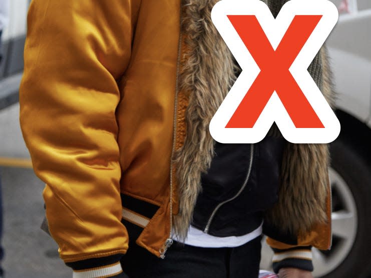 red x over person wearing gold fur bomber jacket