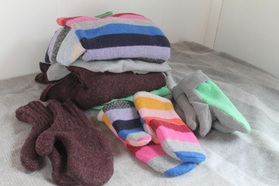 This Feb. 4, 2020 photo taken in Hopkinton, N.H., shows three pairs of handmade mittens, each constructed from sweaters using slightly different techniques. If winter is lasting longer than the groundhog predicted where you live, consider restocking your mitten supply and clearing out your closet at the same time. Instead of tossing stained or accidentally shrunken sweaters, turn them into cozy mittens. (AP Photo/Holly Ramer)
