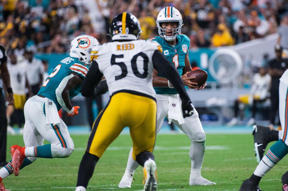 Miami Dolphins quarterback Tua Tagovailoa (1) handles the ball as Pittsburgh Steelers linebacker Malik Reed (50) pressures in the second half during the game between the visiting Pittsburgh Steelers and host Miami Dolphins at Hard Rock Stadium on Sunday, October 23, 2022, in Miami Gardens, FL. Final score, Dolphins 16, Steelers, 10. 