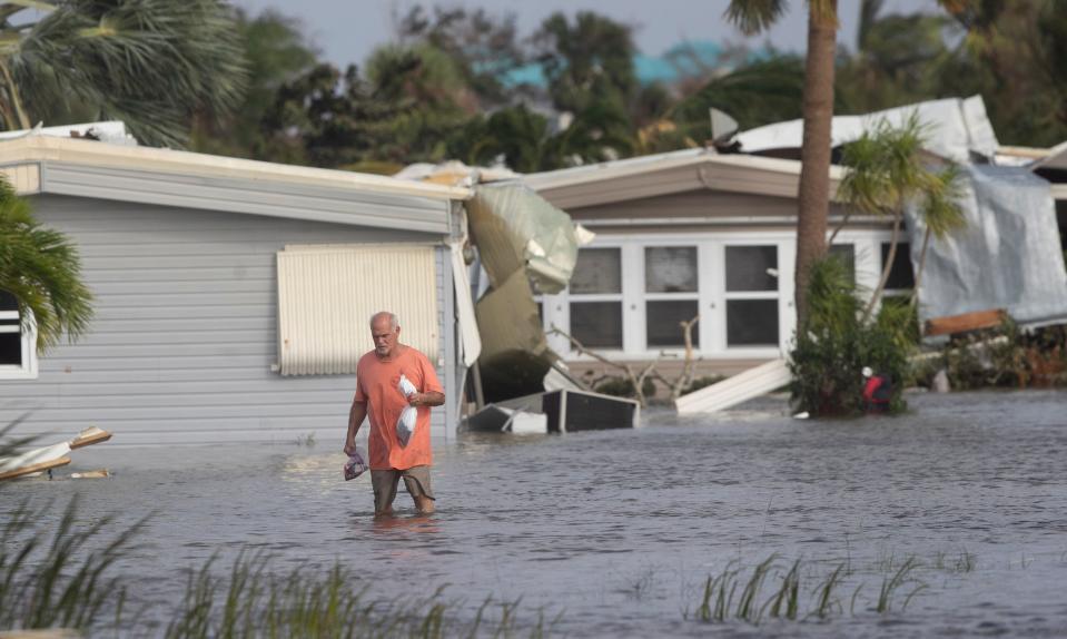 Stan Pentz walks out of a Iona neighborhood  Hurricane Ian made landfall on Wednesday, Sept. 28, 2022.  He survived by swimming in an holding onto items around his home.  