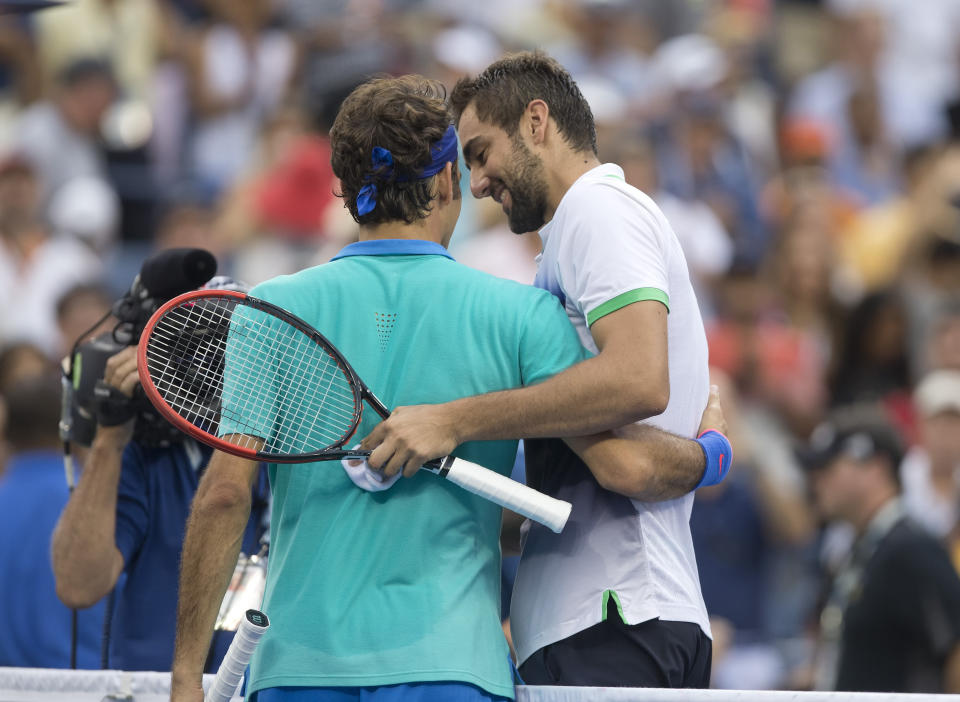 Marin Cilic and Roger Federer hug it out after Cilic defeated the No. 2 seed in straight sets. (Susan Mullane-USA TODAY Sports)