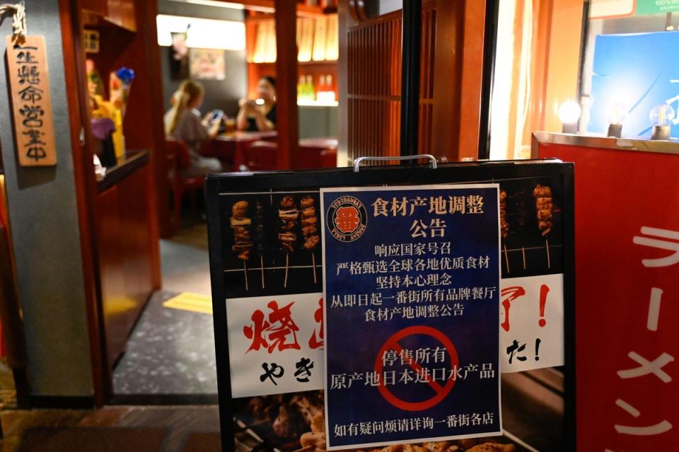File. This picture shows a sign reading ‘suspend the sale of all fish products imported from Japan’ in an area of Japanese restaurants in Beijing, China  (AFP via Getty Images)