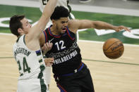 Philadelphia 76ers' Tobias Harris (12) loses control of the ball while being defended by Milwaukee Bucks' Pat Connaughton during the second half of an NBA basketball game Thursday, April 22, 2021, in Milwaukee. (AP Photo/Aaron Gash)