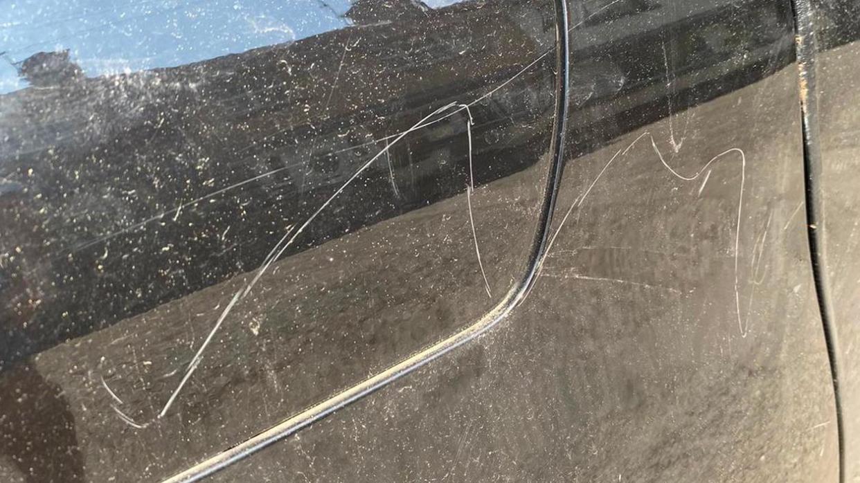 Scrapes on the side of  black car