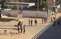 Soldiers stand outside a military base in Burkina Faso's capital Ouagadougou Sunday Jan. 23, 2022. Witnesses are reporting heavy gunfire at a military base raising fears that a coup attempt is underway. Government spokesman Alkassoum Maiga acknowledged the gunfire but denied that the military had taken over the West African country. (AP Photo/Sam Mednick)