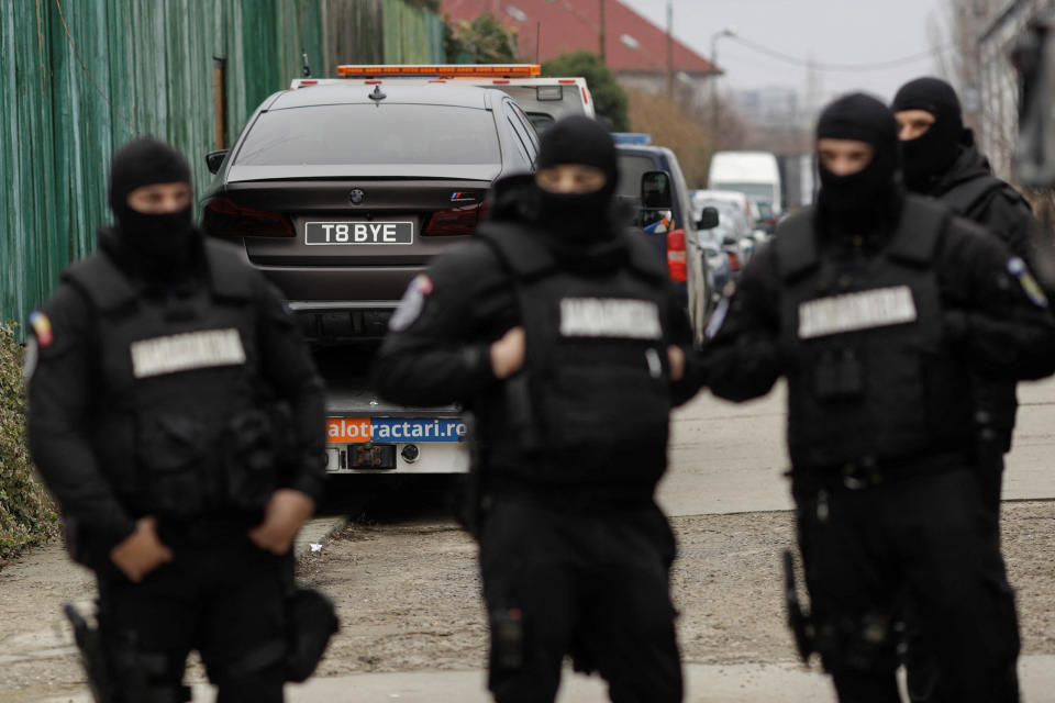 Romanian officials transport the cars seized from the Tate compund to an undisclosed storage location, from Voluntari, Ilfov, Romania, on Jan. 14.