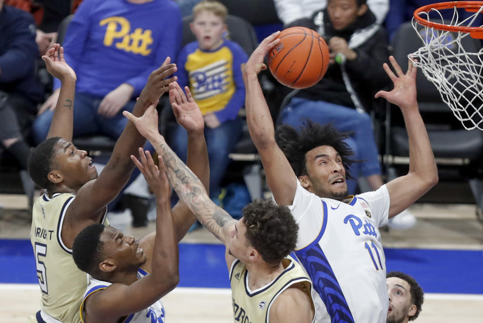 Pittsburgh's Justin Champagnie (11) goes to the hoop to score past Georgia Tech's Moses Wright (5) during the second half of an NCAA college basketball game, Saturday, Feb. 8, 2020, in Pittsburgh. Pittsburgh won 73-64. (AP Photo/Keith Srakocic)