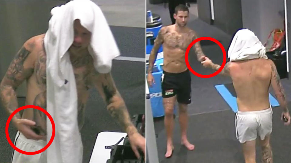 Seen here, Jordan De Goey passes a mobile phone to Jeremy Howe in the Collingwood change rooms.