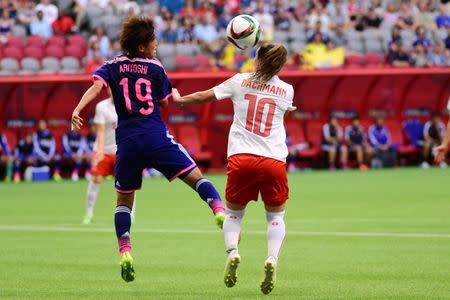 Jun 8, 2015; Vancouver, British Columbia, CAN; Japan defender Saori Ariyoshi (19) and Switzerland forward Ramona Bachmann (10) battle for the ball in the first half in a Group C soccer match in the 2015 women's World Cup at BC Place Stadium. Mandatory Credit: Anne-Marie Sorvin-USA TODAY Sports