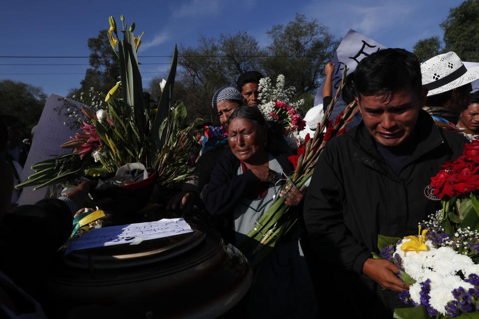 Mourners hold wreaths around the coffin of a supporter of former President Evo Morales killed during clashes with security forces in Sacaba, Bolivia, Saturday, Nov. 16, 2019. Bolivian security forces clashed with Morales' supporters in a central town Friday, leaving at least five people dead, dozens more injured and escalating the challenge to the country's interim government to restore stability. (AP Photo/Juan Karita)