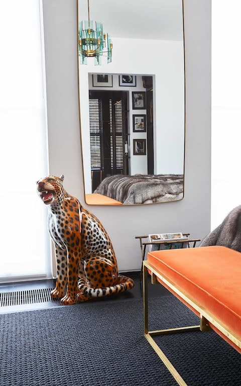 Angela Radcliffe modern minimal interior design home orange bench leopard statue - Credit: Kate Martin