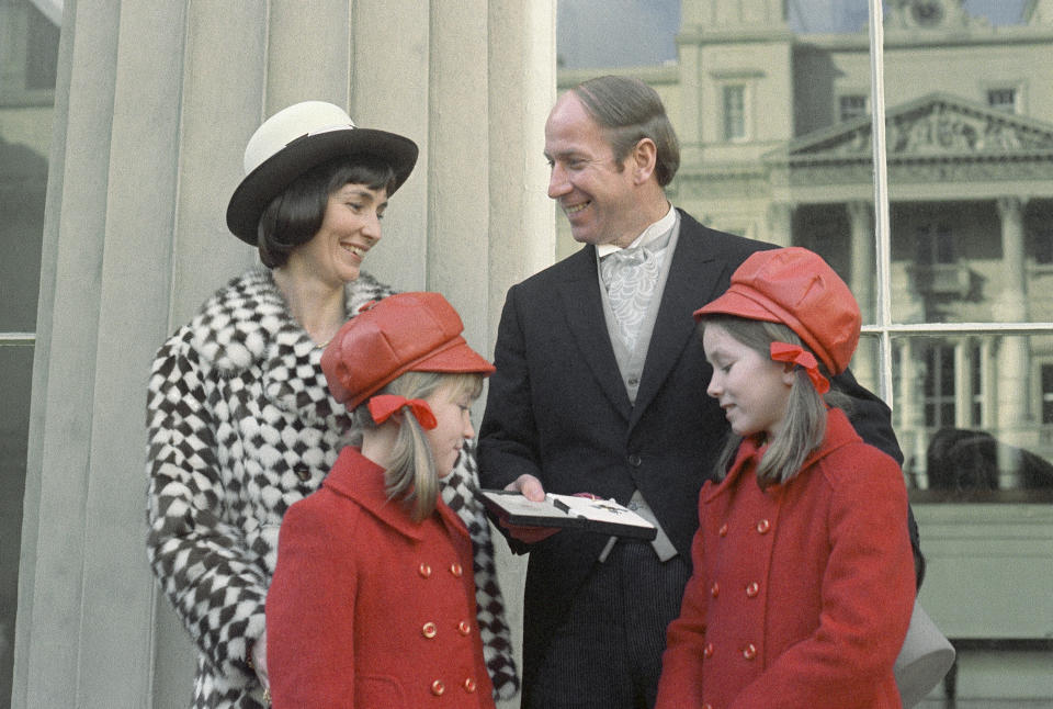 FILE - Former British soccer star Bobby Charlton, now a football team manager, at Buckingham Palace, London, for a medal presentation, surrounded by his wife and children, in Feb, 1974. Bobby Charlton, an English soccer icon who survived a plane crash that decimated a Manchester United team destined for greatness to become the heartbeat of his country's 1966 World Cup-winning team, has died. He was 86. A statement from Charlton's family, released by United, said he died Saturday Oct. 21, 2023 surrounded by his family. (AP Photo/File)