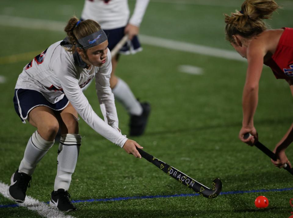 Ketcham's Katie Sauve looks to force a turnover against a Carmel player during a Section 1 Class AA field hockey quarterfinal on October 27, 2021.