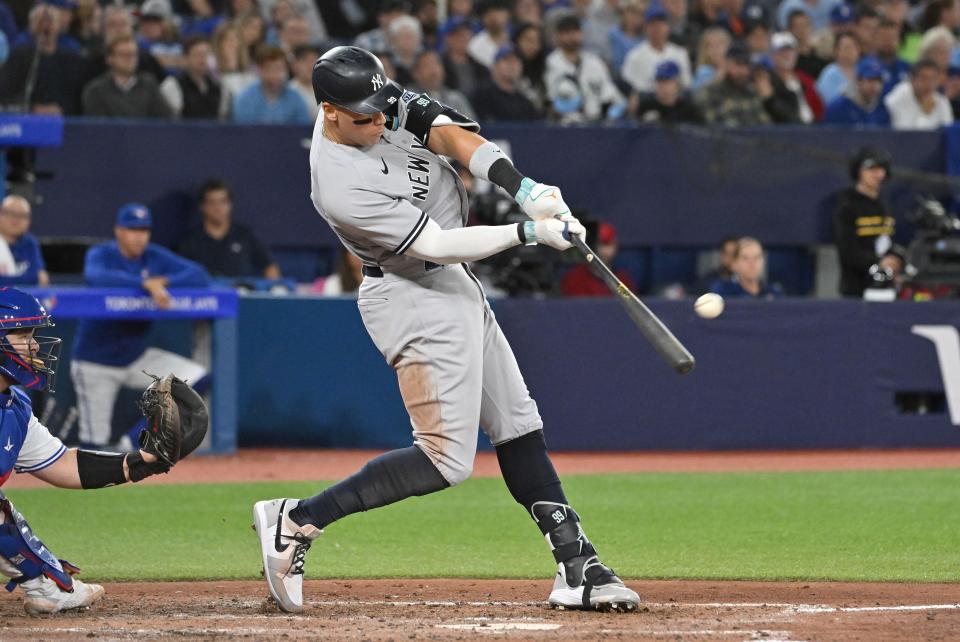 Sep 27, 2023; Toronto, Ontario, CAN; New York Yankees right fielder Aaron Judge (99) hits a two run home run against the Toronto Blue Jays in the seventh inning at Rogers Centre. Mandatory Credit: Dan Hamilton-USA TODAY Sports