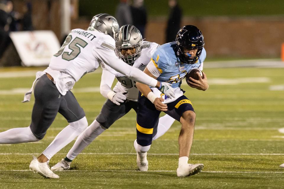 Kent State quarterback Collin Schlee scrambles with the ball during the first half against Eastern Michigan, Wednesday, Nov. 16, 2022 in Kent.