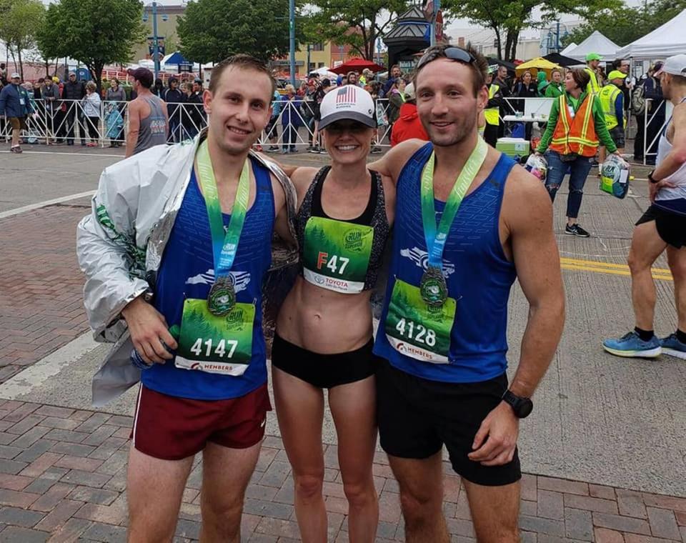 Paula Pridgen poses with Charlotte running friends Reed Payne (left) and Chad Crockford (right) shortly after she qualified for the U.S. Olympic Marathon Trials in Duluth, Minn., in 2018.