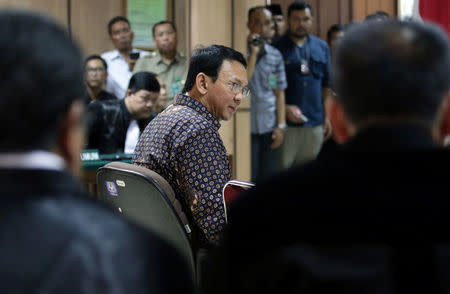 Jakarta's governor Basuki Tjahaja Purnama looks at his lawyers inside the court room during his trial at the North Jakarta District Court in Jakarta, Indonesia December 27, 2016. REUTERS/Bagus Indahono/Pool