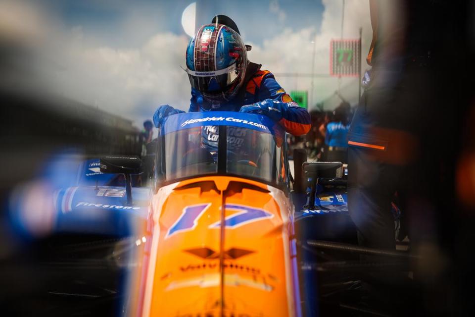 Kyle Larson climbs into his car to qualify for the Indianapolis 500.