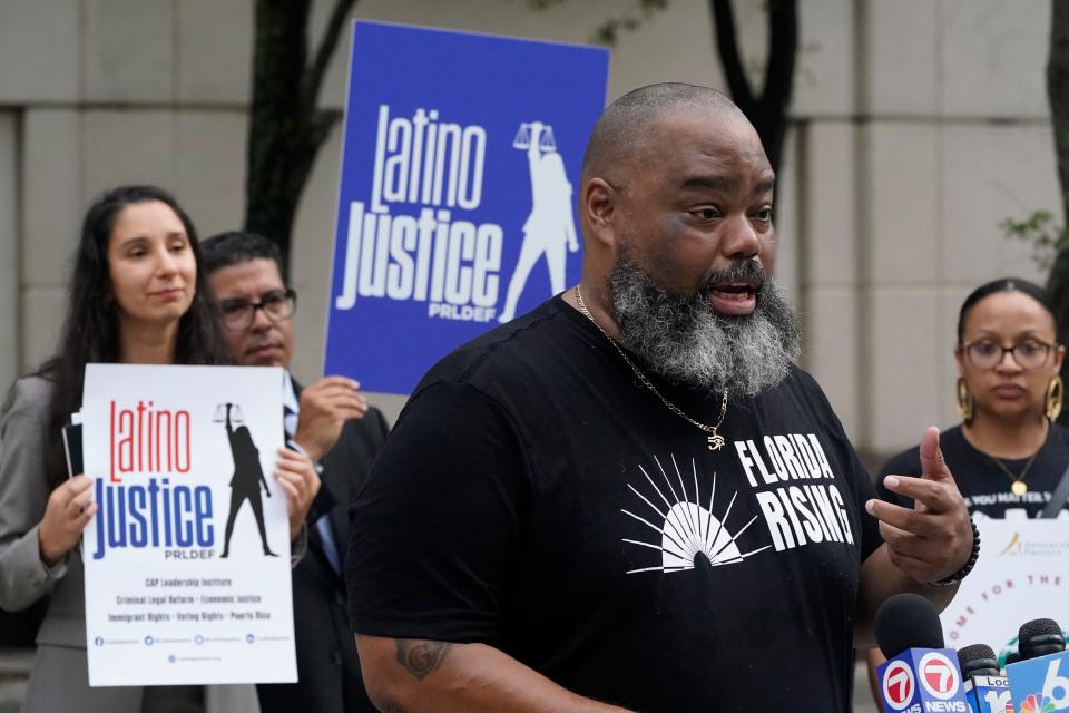 Joined by members of civil rights and voting rights groups, Fla. Sen. Dwight Bullard, foreground, speaks during a news conference, Thursday, Sept. 15, 2022, in front of the James Lawrence King Federal Justice Building in downtown Miami. The coalition said that the State of Florida appealed the United States District Court for the Northern District of Florida's decision striking down provisions of SB90 that would make it harder to access secure ballot drop boxes, deter third-party voter regisÂ­traÂ­tion organizations from registering people to vote, and restrict the abil­ity to provide food and water to voters waitÂ­ing in long lines on Election Day