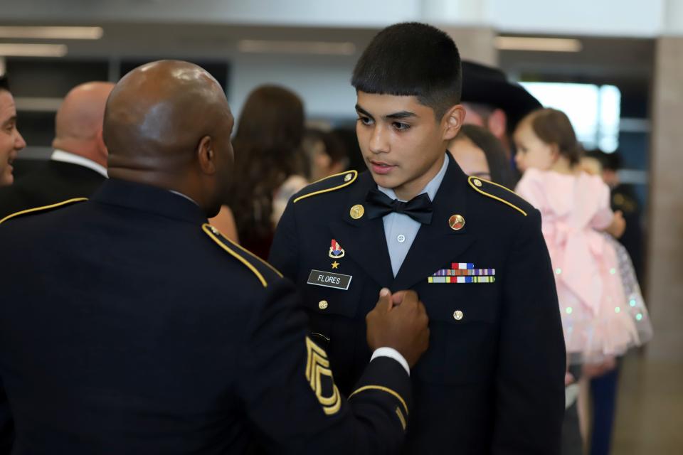 Freshman cadet PFC Manuel Flores visits with Sgt. 1st Class Christopher Ray during Friday's return of the Deming High JROTC Wildcat Battalion's Military Ball.