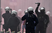 Riot police officers deployed to block the street during a protest against coronavirus measures in Brussels, Belgium, Sunday, Dec. 5, 2021. Hundreds of people marched through central Brussels on Sunday to protest tightened COVID-19 restrictions imposed by the Belgian government to counter the latest spike in coronavirus cases. (AP Photo/Geert Vanden Wijngaert)