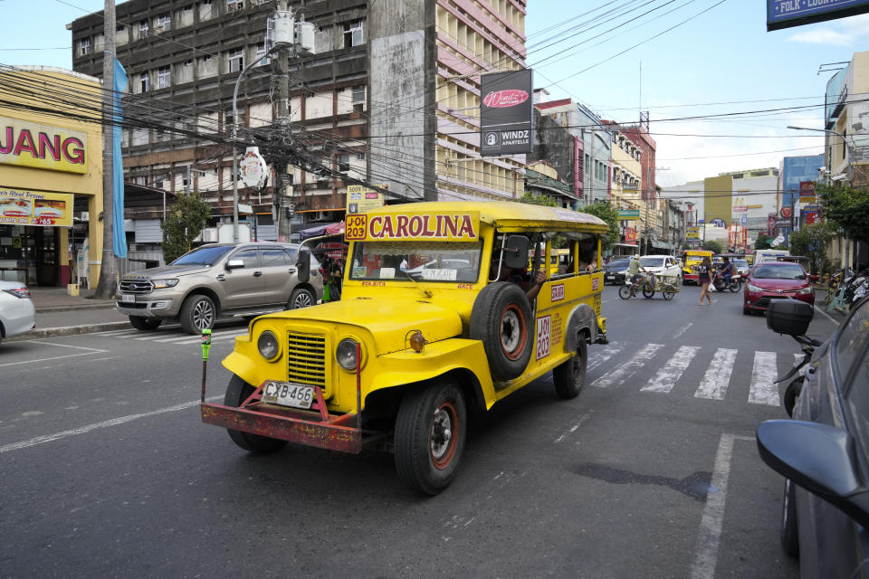 A vintage passenger jeepney passes by a road just outside what used to be America's largest overseas naval base at Olongapo city, Zambales province, northwest of Manila, Philippines on Monday Feb. 6, 2023. The U.S. has been rebuilding its military might in the Philippines after more than 30 years and reinforcing an arc of military alliances in Asia in a starkly different post-Cold War era when the perceived new regional threat is an increasingly belligerent China. (AP Photo/Aaron Favila)