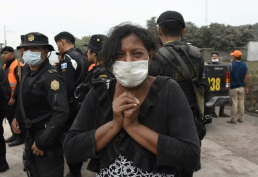 A woman cries for her missing relatives during the search for vicitms in San Miguel Los Lotes, a village in Escuintla Department, about 35 km southwest of Guatemala City, on June 4, 2018, a day after the eruption of the Fuego Volcano