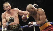 Beibut Shumenov, left, of Kazakhstan, and Bernard Hopkins, right, of the United States, fight during the eighth round of their IBF, WBA and IBA Light Heavyweight World Championship unification boxing match, Saturday, April 19, 2014, in Washington. Hopkins won by a split decision. (AP Photo/Luis M. Alvarez)