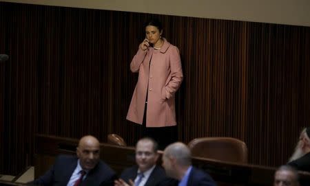 Israel Justice Minister Ayelet Shaked speaks on her mobile phone during a session for a no-confidence vote at the Israeli Parliament in Jerusalem February 8, 2016. REUTERS/Ronen Zvulun