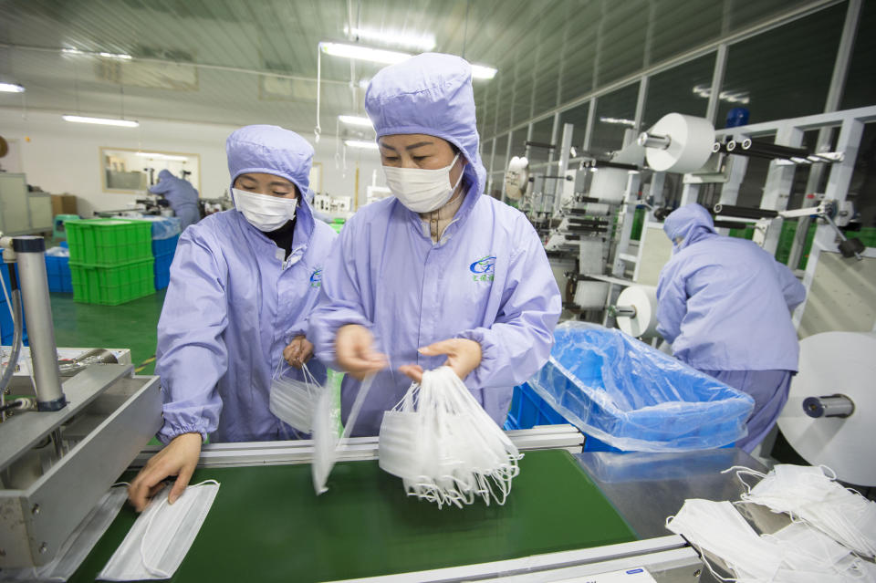 FILE - In this Jan. 28, 2020 file photo, people work on a production line at a factory for medical masks in Hai'an in eastern China's Jiangsu Province. The U.S. ambassador to China Terry Branstad said Wednesday, April 15, 2020, that he doesn't believe Beijing is deliberately blocking exports of personal protective equipment and medical supplies, adding that the shipment of 1,200 tons of such products to the U.S. could not have been possible without Chinese support. (Chinatopix via AP, File)