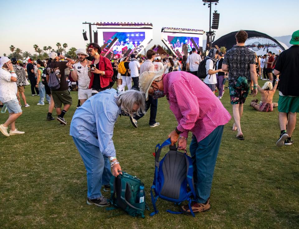 Sally and Bob Arroyo stake out a spot in the grass to check out Adam Ten x Mita Gami at the Quasar Stage during the Coachella Valley Music and Arts Festival in Indio, Calif., Friday, April 19, 2024.