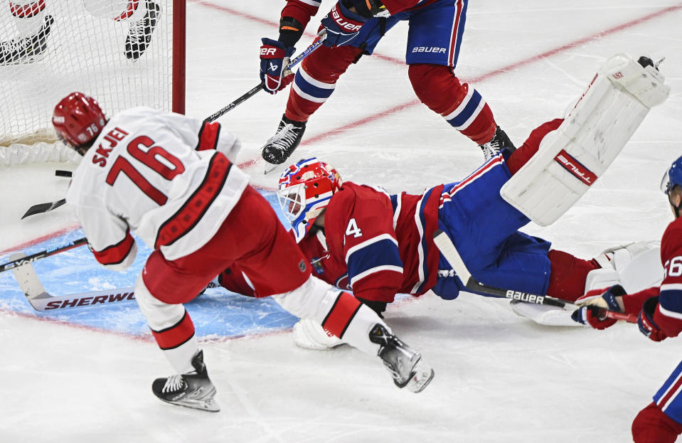 Montreal Canadiens goaltender Jake Allen gives up a goal to Carolina Hurricanes' Brady Skjei (76) during the second period of an NHL hockey game Tuesday, March 7, 2023, in Montreal. (Graham Hughes/The Canadian Press via AP)