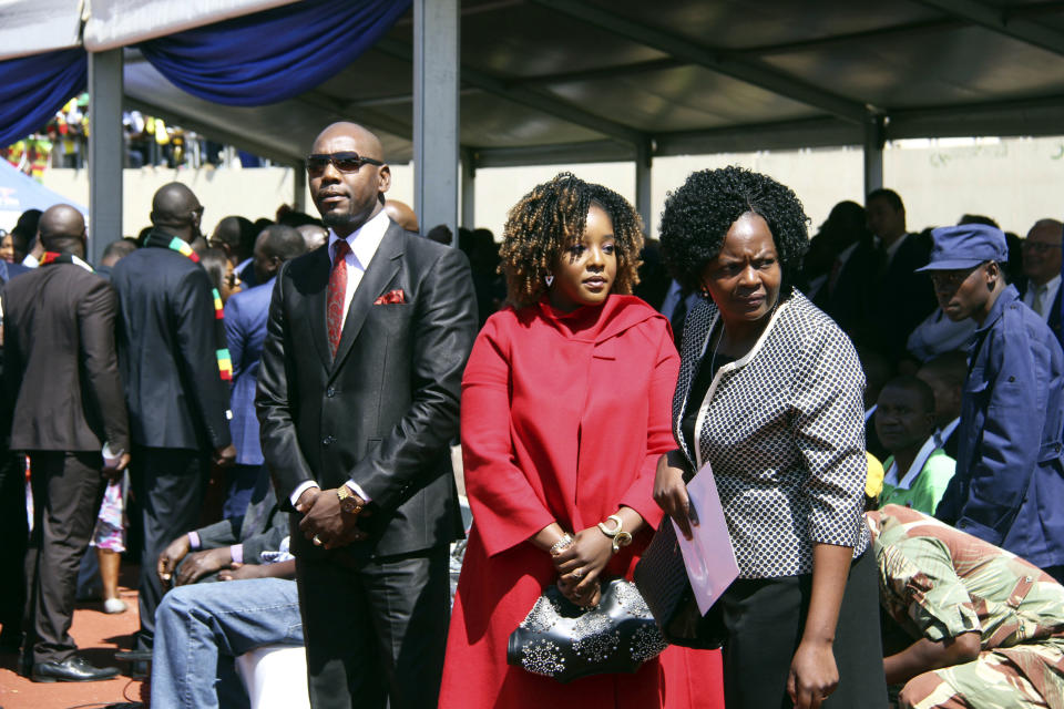 Daughter of Former Zimbabwean President Robert Mugabe, Bona Mugabe, centre, and her husband Simba Chikore attend new Zimbabwean President Emmerson Mnangagwa's inauguration ceremony at the National Sports Stadium in Harare, Sunday, Aug. 26, 2018. Zimbabwe on Sunday inaugurated a president for the second time in nine months as a country recently jubilant over the fall of longtime leader Robert Mugabe is now largely subdued by renewed harassment of the opposition and a bitterly disputed election. (AP Photo/Tsvangirayi Mukwazhi)
