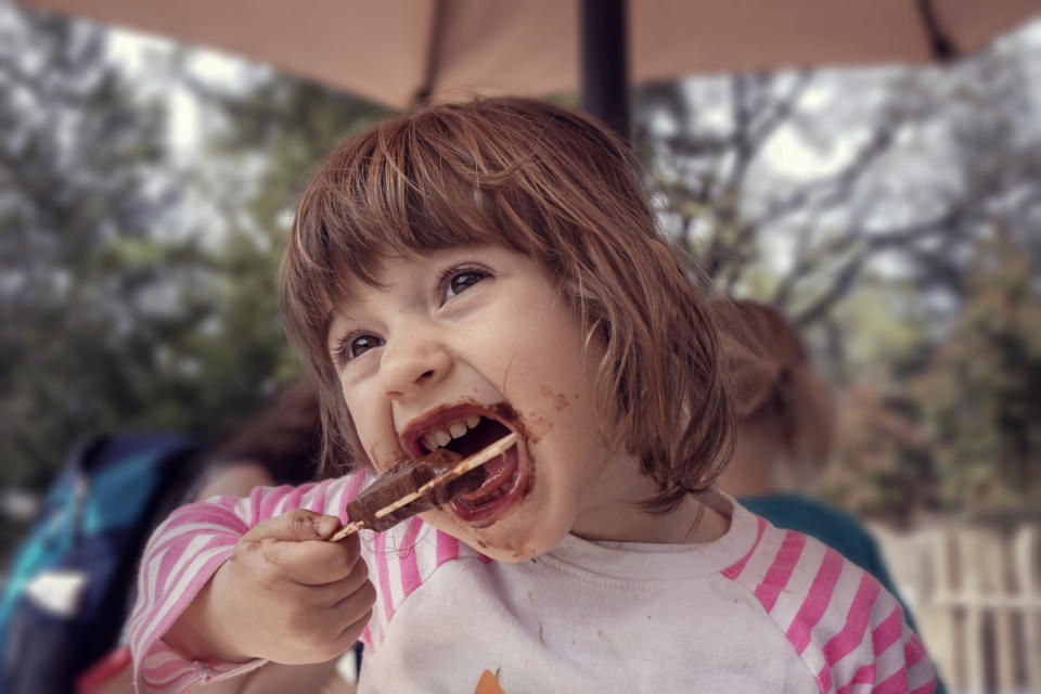 A kid eating a popsicle