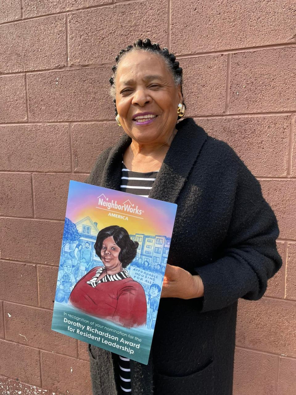 Gladys Muhammad the recognition plate she received as one of five 2023 national winners of NeighborWorks America’s Dorothy Richardson Award for Resident Leadership. She and the others will be honored Oct. 27 at a ceremony during the organization’s Community Leadership Institute.