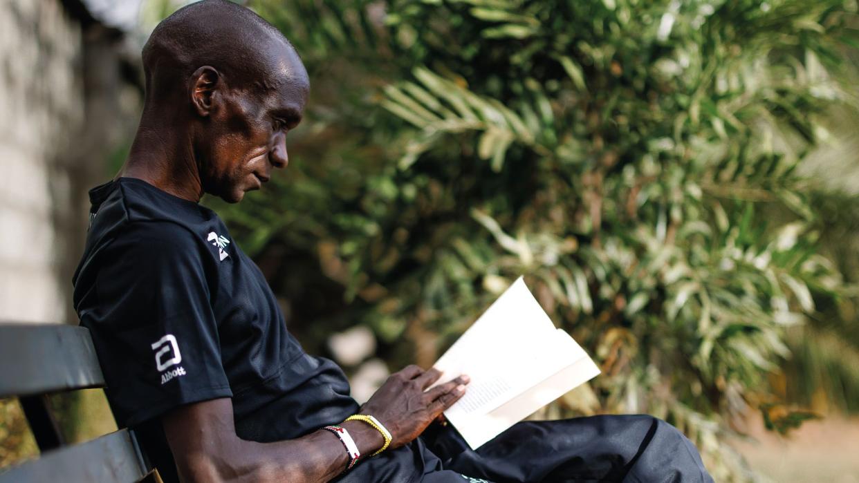 eliud kipchoge takes a quiet moment at home in elodoret, kenya, to read a book