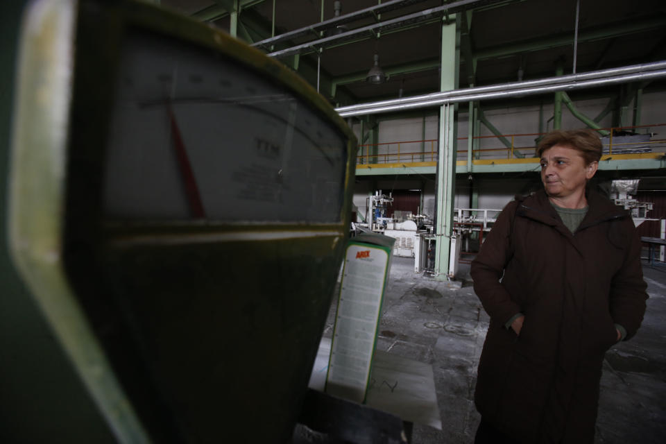 Vidosava Jovanovic, an employee of the detergent factory "Dita" looks at her former work place inside the factory in the Bosnian town of Tuzla, 140 kms north of Sarajevo on Wednesday, Feb. 12, 2014. The violence engulfing Bosnia in recent days, with scenes of burning government buildings and protesters pelting police with stones, has many root causes. One of them is the failed privatizations of state-owned companies. (AP Photo/Amel Emric)