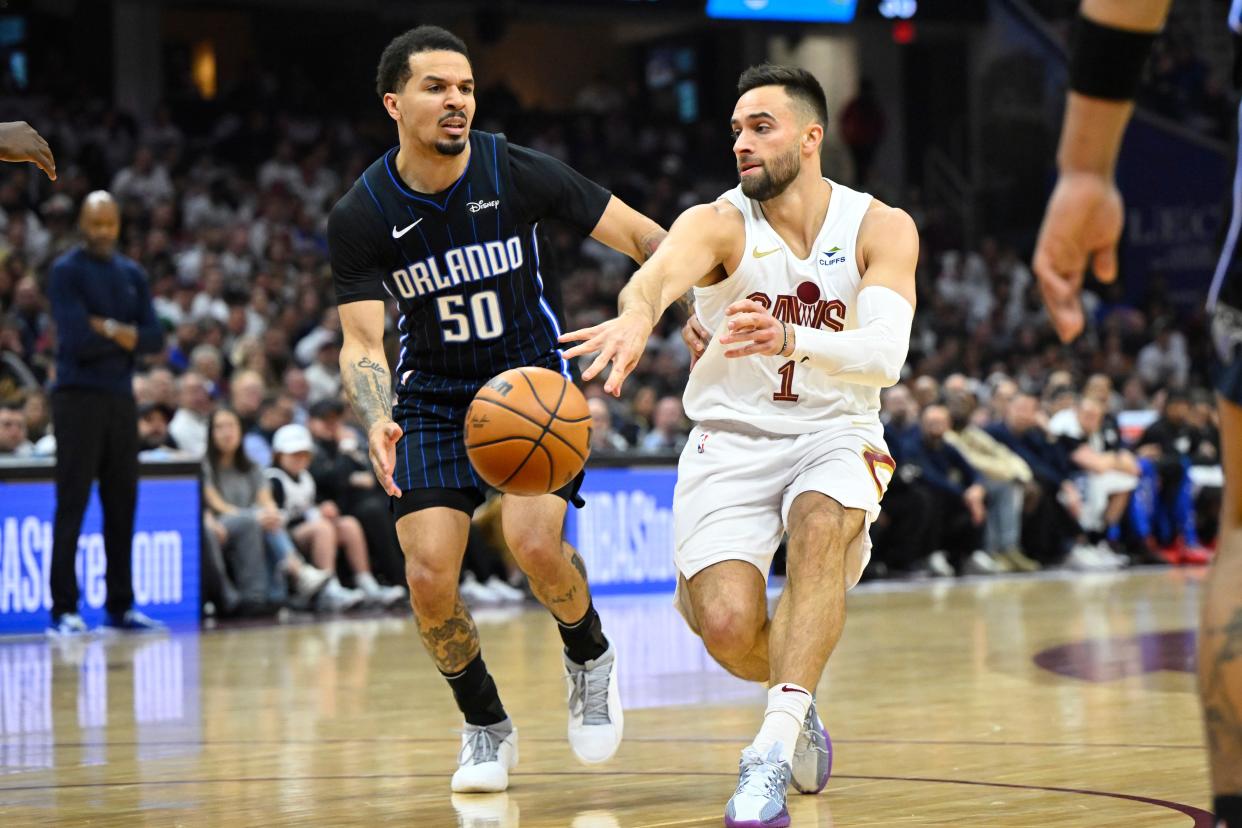 Cavaliers guard Max Strus (1) throws a pass as Orlando Magic guard Cole Anthony (50) defends in the second quarter during Game 2 of the first-round playoff series, April 22, 2024, in Cleveland.