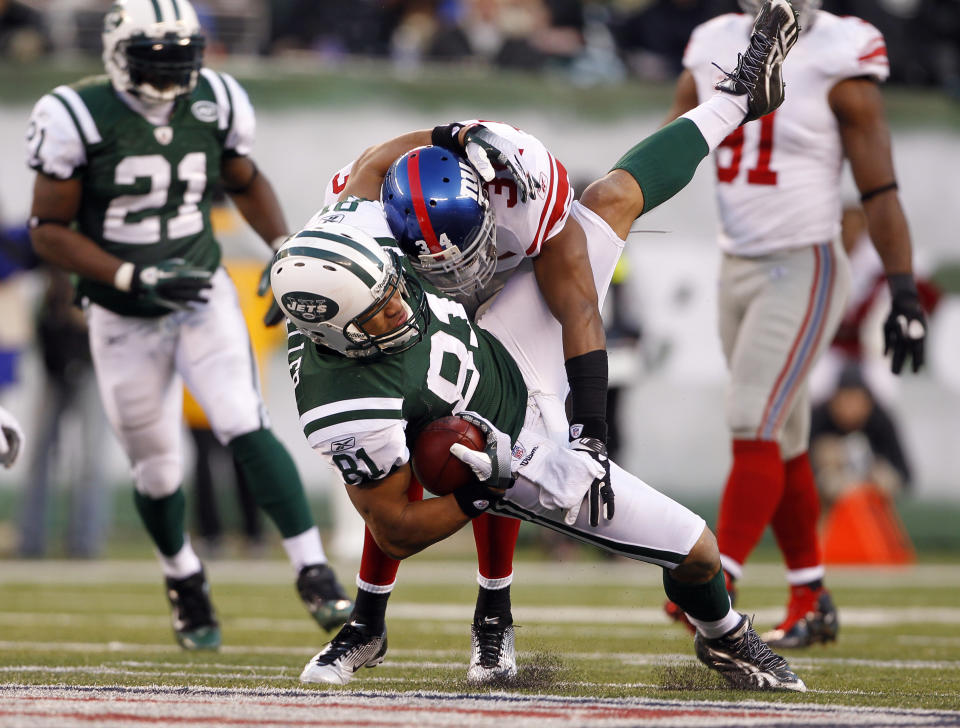 Dustin Keller #81 of the New York Jets makes a catch and is tackled by Deon Grant #34 of the New York Giants during the third quarter at MetLife Stadium on December 24, 2011 in East Rutherford. New Jersey. (Photo by Rich Schultz /Getty Images)