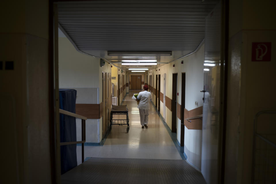 In this Nov. 16, 2018, photo, a nurse carries a newborn baby at the Kezmarok hospital in Kezmarok, Slovakia. An investigation by The Associated Press has found that women and their newborns in Slovakia are routinely, unjustifiably and illegally detained in hospitals across the European Union country. (AP Photo/Felipe Dana)